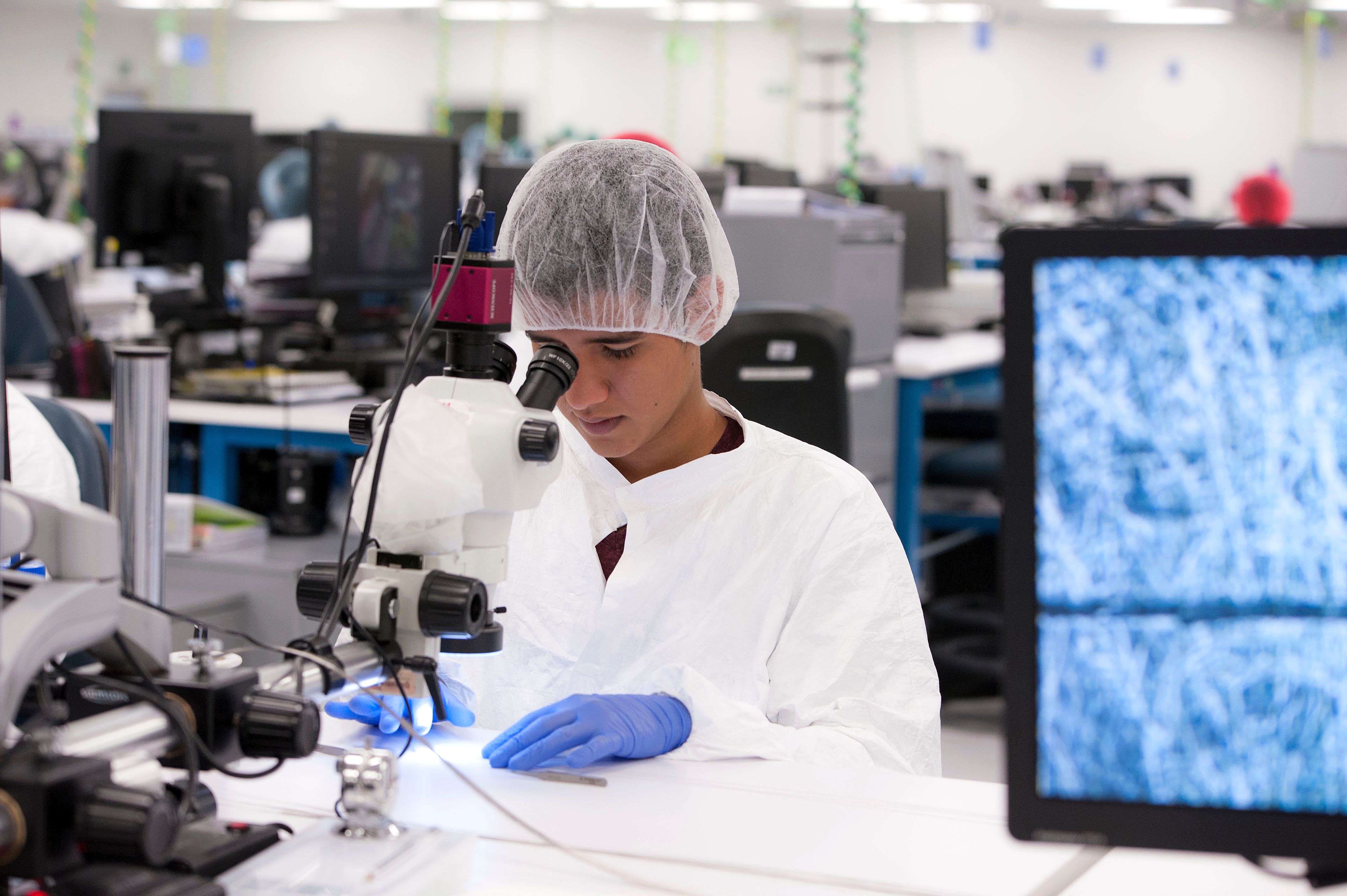 Quality assurance in Costa Rica A Costa-Rican employee of Microvention inspecting a device for quality assurance.